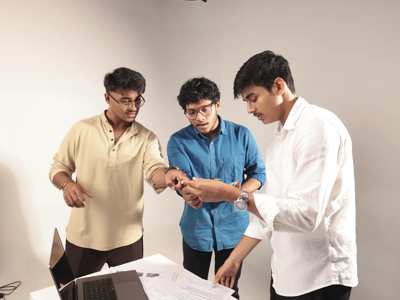 Three founders reviewing an early idea together in the studio